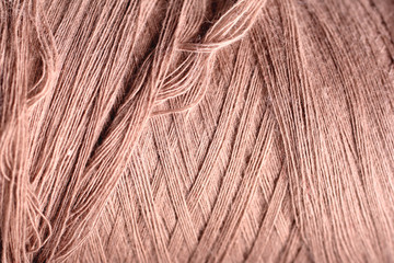 beige thread fabric wool yarn wrapped in a spool