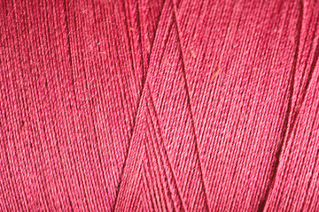 red thread fabric wool yarn wrapped in a spool