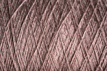 brown thread fabric wool yarn wrapped in a spool