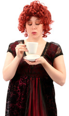 woman with red curly hair drinking tea or coffee