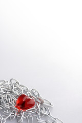 Red Heart laying in a metal chain in a corner of the staff