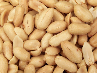 Full frame close-up photograph of salted party peanuts.