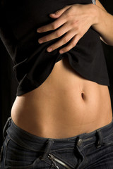 Naklejka premium Sexy girl pose. Jeans, hand and belly