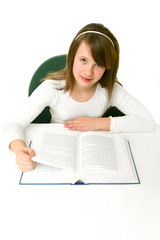 Portrait of Happy young schoolgirl reading book