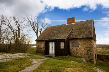 Fototapeta na wymiar An old stone house on a big landscape