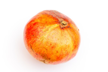 One yellow-orange pomegranate isolated on white
