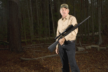 man coming out of the woods with an AR 15