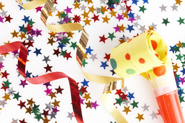 red and golden ribbons and small confetti stars, party time