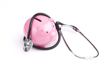 piggy bank and stethoscope, finance diagnosis concept