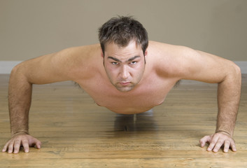 Fototapeta na wymiar young man doing pushups