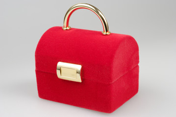 Closed red jewelry box isolated over gray background