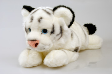 Pretty tiger toy isolated over gray background