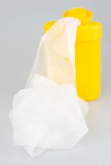 Crumpled tissues near cup isolated over gray background
