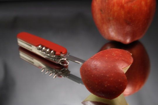 Incised apple heart and red apple with knife