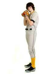 Fototapeta na wymiar A young male baseball player pitching.