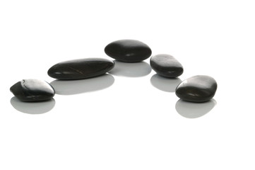 Five black pebbles.