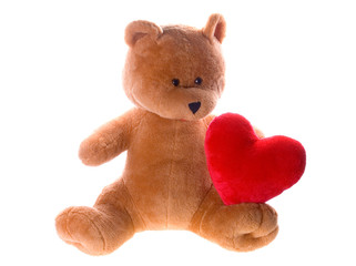 Teddy bear with big red heart isolated