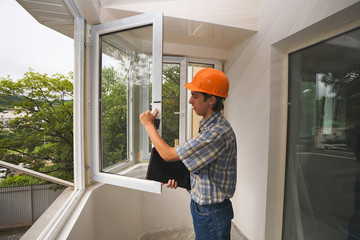 Build inspector checks quality of installation of new windows..