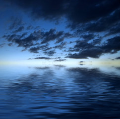 Dark dramatic clouds over water