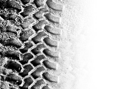 Tyre tread pattern in sand with area of copyspace
