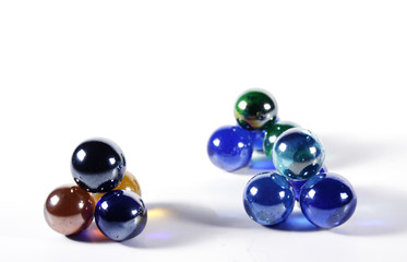 Marbles in various colors on white background