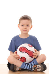 6 years old boy with soccer ball isolated on white