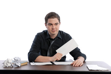 Business man sitting at desk holding blank envelope