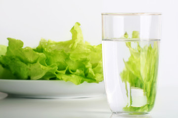 fresh iceberg salad with a glass of water