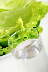 fresh iceberg salad with a glass of water