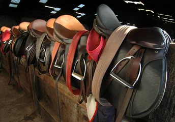 Acrylic prints Horse riding Saddles in the barn