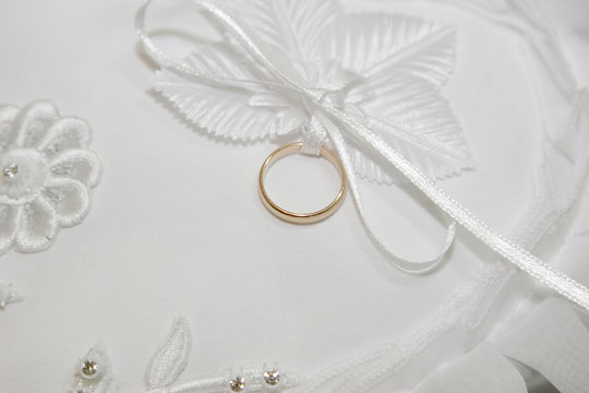 wedding ring on white pillow