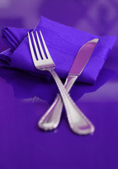 A bright and colorful table setting in purple