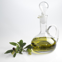 bottle with fine olive oil and a branch of an olive tree