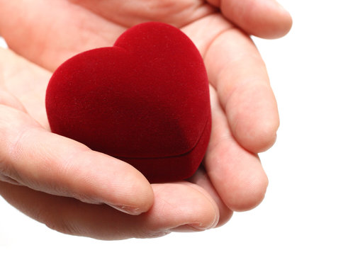 man's hands gifting heart on valentine day isolated on white