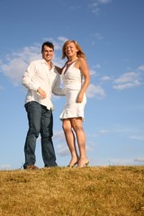 couple stand on meadow