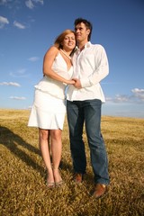 couple stand on meadow