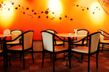 Beautiful white chairs in modern night cafe