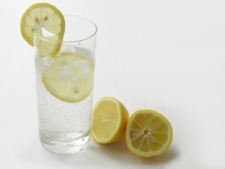 minerale water with lemon slices,lemons and pipe for drinking
