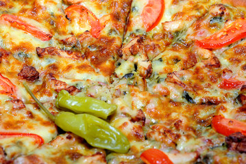 Close-up view to chicken pizza with pepperoni, tomato