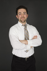 Caucasian businessman standing on gray background 