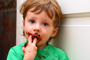 The little boy enjoying a zephyr in chocolate