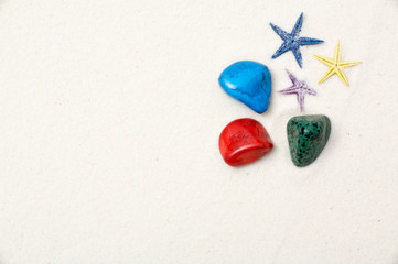 colorful stones and starfishes in the white sand