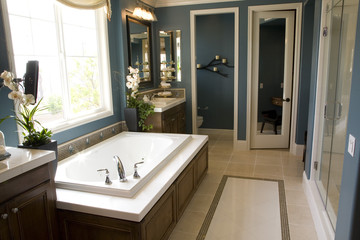 Spacious bathroom with a modern tub and tile floor.