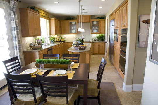 Spacious kitchen with table and island.