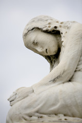 Statue of a crying girl in an historic New Orleans cemetery