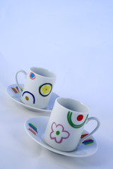 two cups of coffee with color flowers (soft and selective focus)