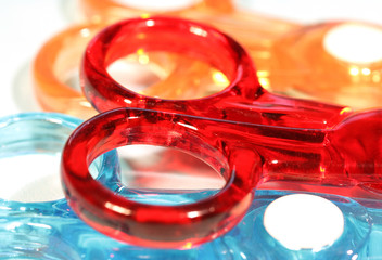 Details of plastic scissors in red, orange and blue