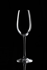 Glass of champagne (flute) on black background