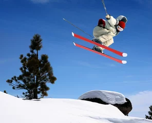 Fotobehang A young man jumping high at Lake Tahoe resort © Galina Barskaya