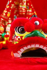 Close up of chinese lion head decoration over red background